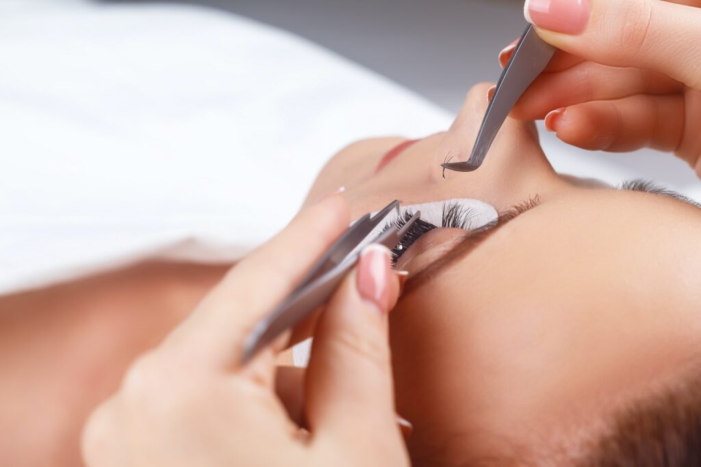 Eyelash Extension Procedure. Woman Eye with Long Eyelashes. Eyelashes with rhinestone. Lashes, close